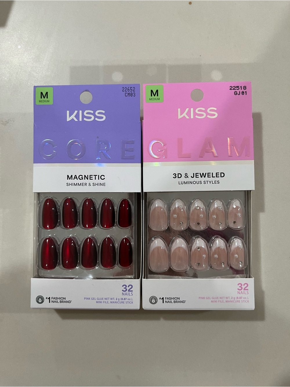Kiss Press-On Nail Packs in Purple & Pink Packaging